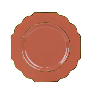 Coral decorative plate with gold trim on a plain background