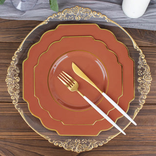 Elegant dinnerware set with decorative plates and gold-accented utensils.
