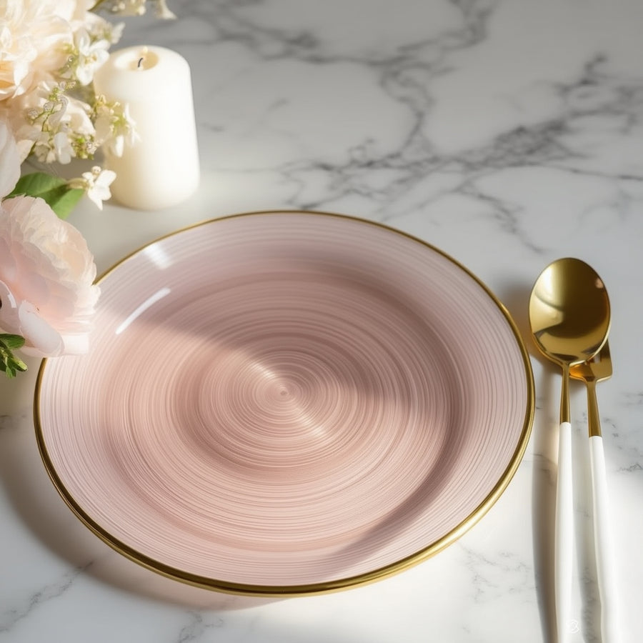 Elegant pink plate with gold rim, styled with flowers and a candle.