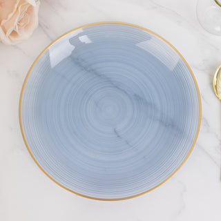 Blue decorative plate with gold rim and marble design on white background.