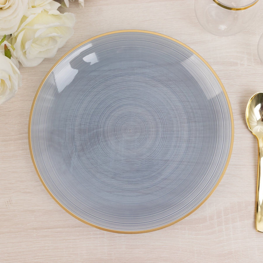 Gray decorative plate with gold rim on a light wooden surface.