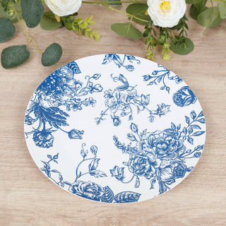 Blue floral design plate on a wooden surface with greenery.