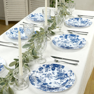Elegant blue and white floral dinnerware set on a dining table.