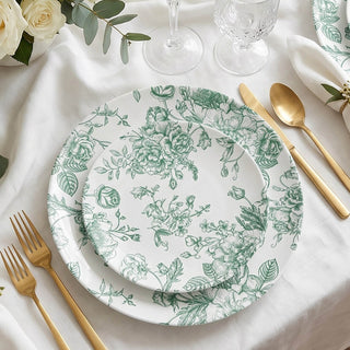 Elegant floral dinnerware set with gold cutlery on a white table setting