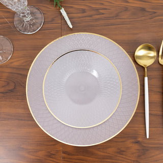 Elegant layered plates with gold trim on a wooden table setting.