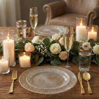 Elegant dinner table setup with candles, flowers, and glassware.