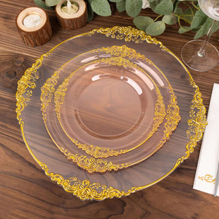 Elegant clear plates with gold floral design on wooden table.