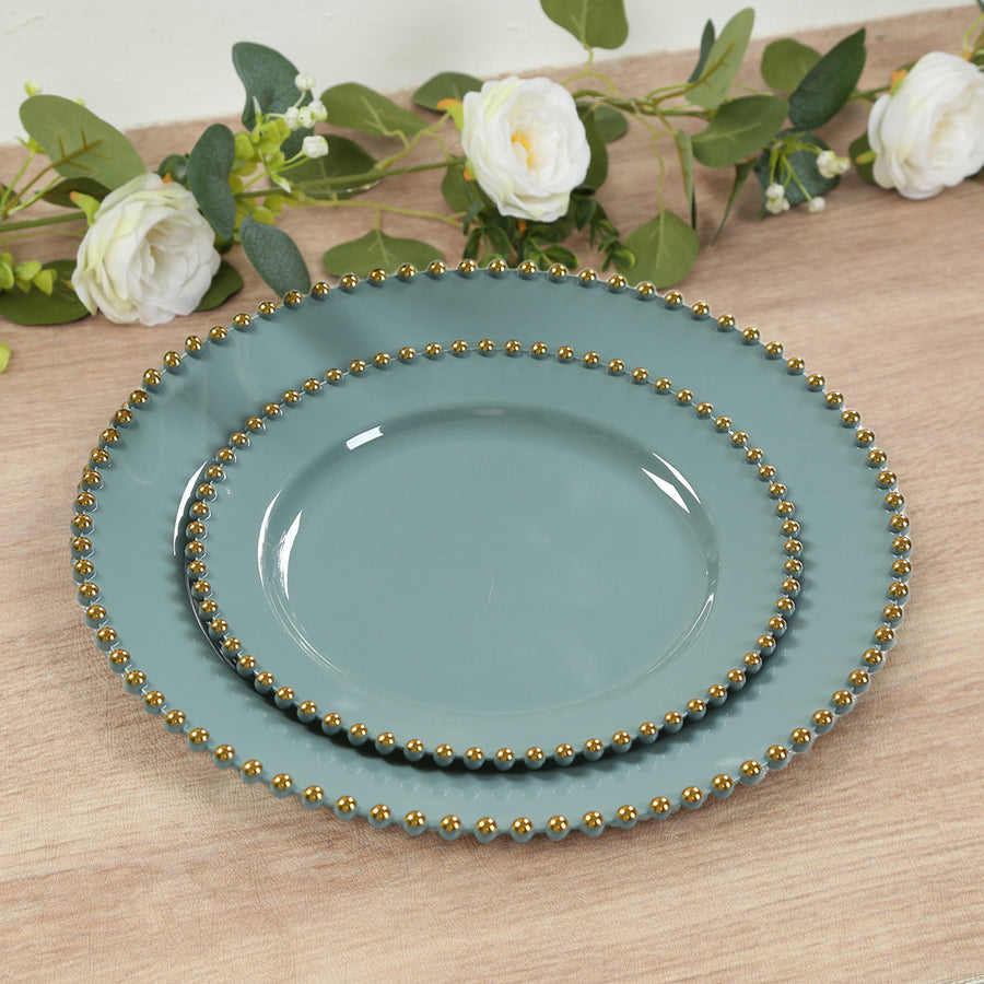 Set of three decorative plates in teal with gold beaded edges.