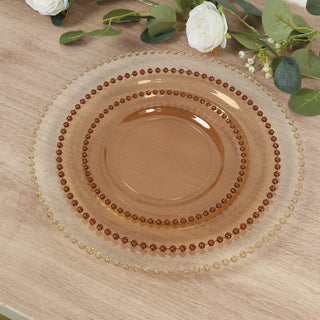 Elegant amber glass plate with decorative beaded rim.