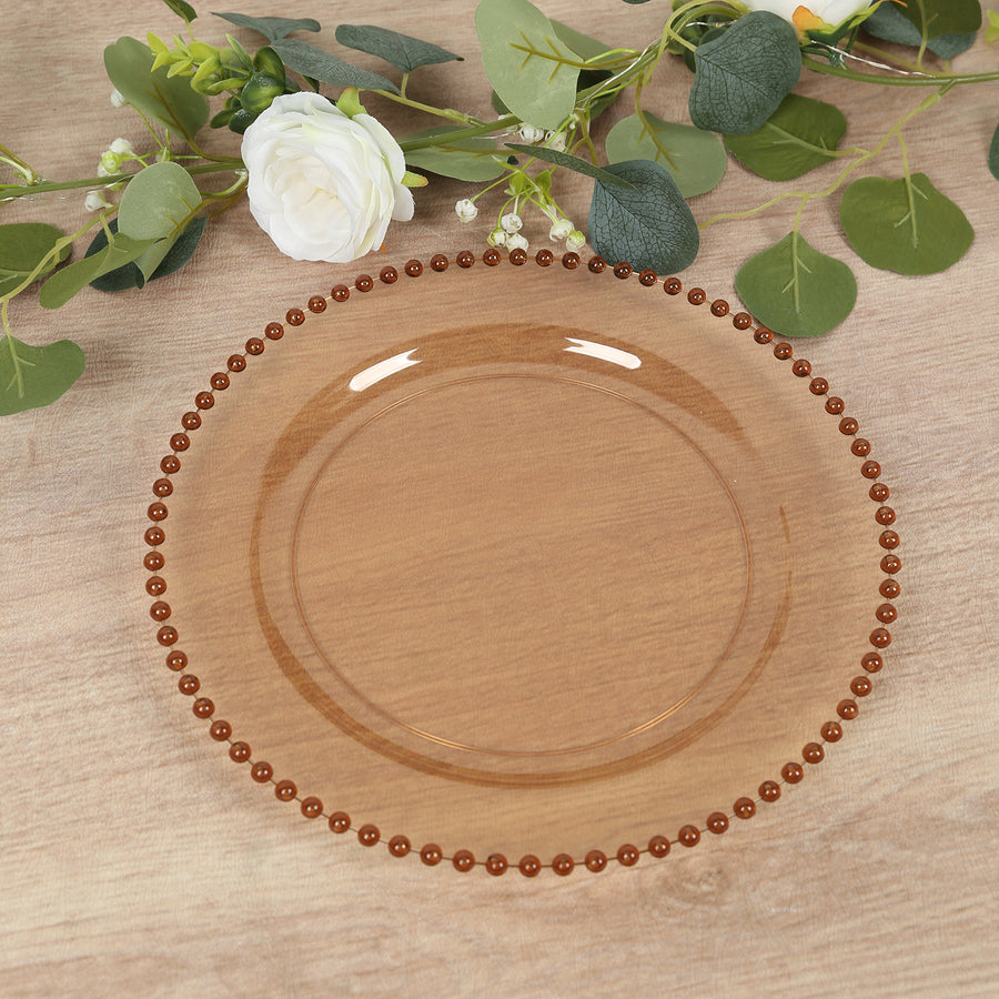 Amber glass plate with beaded rim, perfect for elegant dining settings.