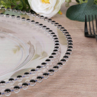 Elegant clear plate with black beaded rim on a wooden table.