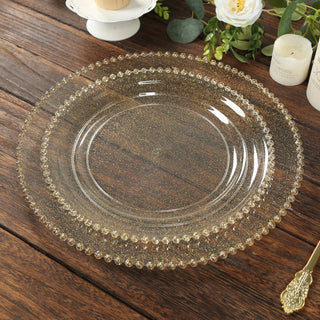 Elegant gold-rimmed glass plate on rustic wooden table.
