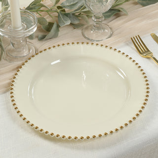 Elegant cream plate with gold beaded rim on a dining table.