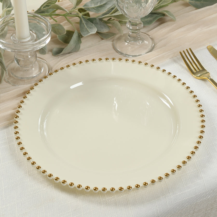 Elegant cream plate with gold beaded rim on a dining table.