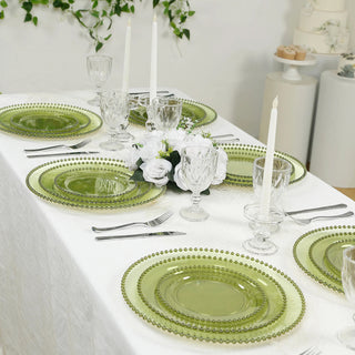 Elegant green glass dinnerware set on a beautifully styled dining table.