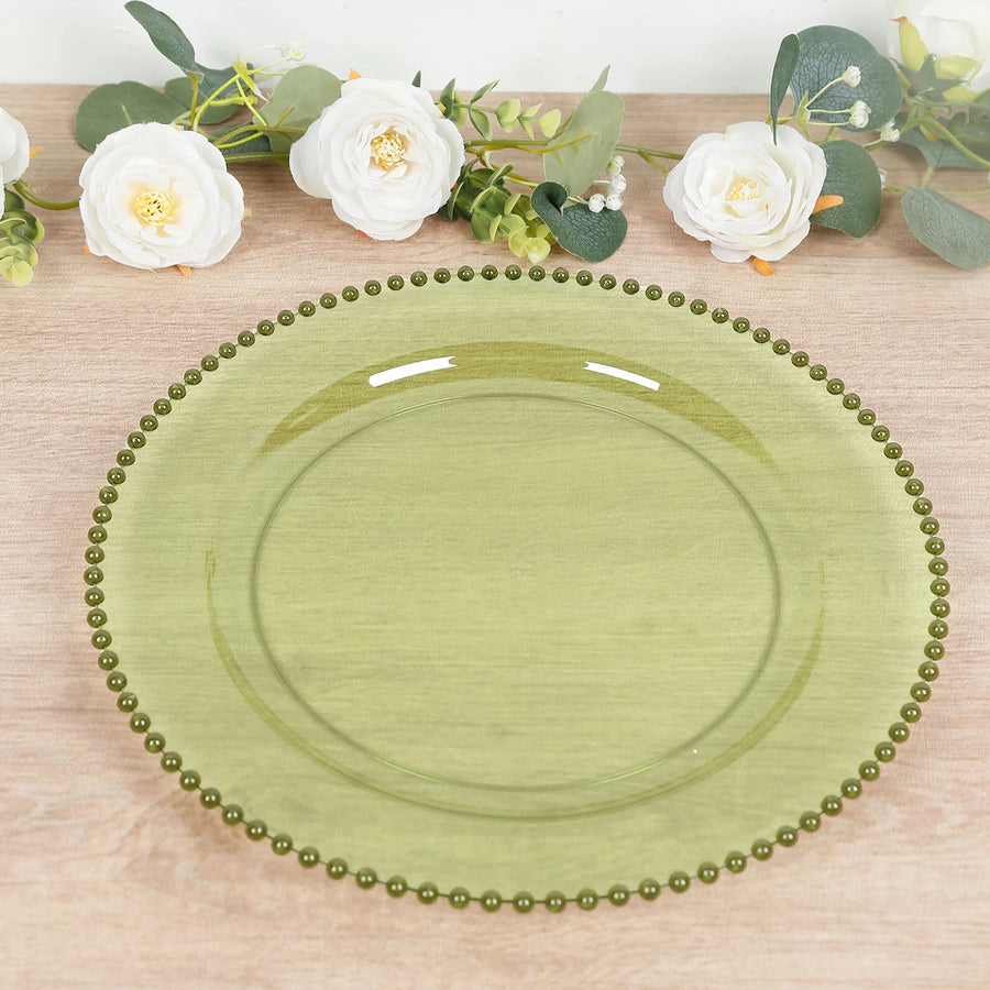 Green glass plate with decorative beaded rim on a wooden table.