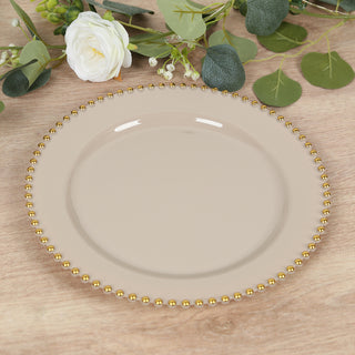 Beige decorative plate with gold bead trim on a wooden surface.