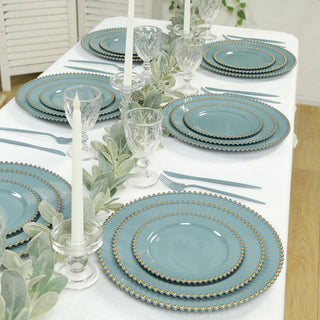 Elegant blue dinnerware set with gold accents on a beautifully styled table.