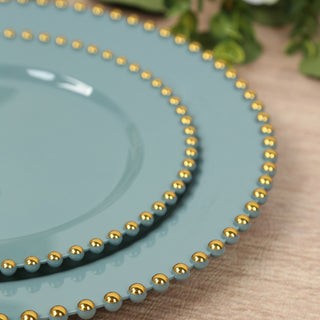 Elegant teal plates with gold beaded trim displayed together.