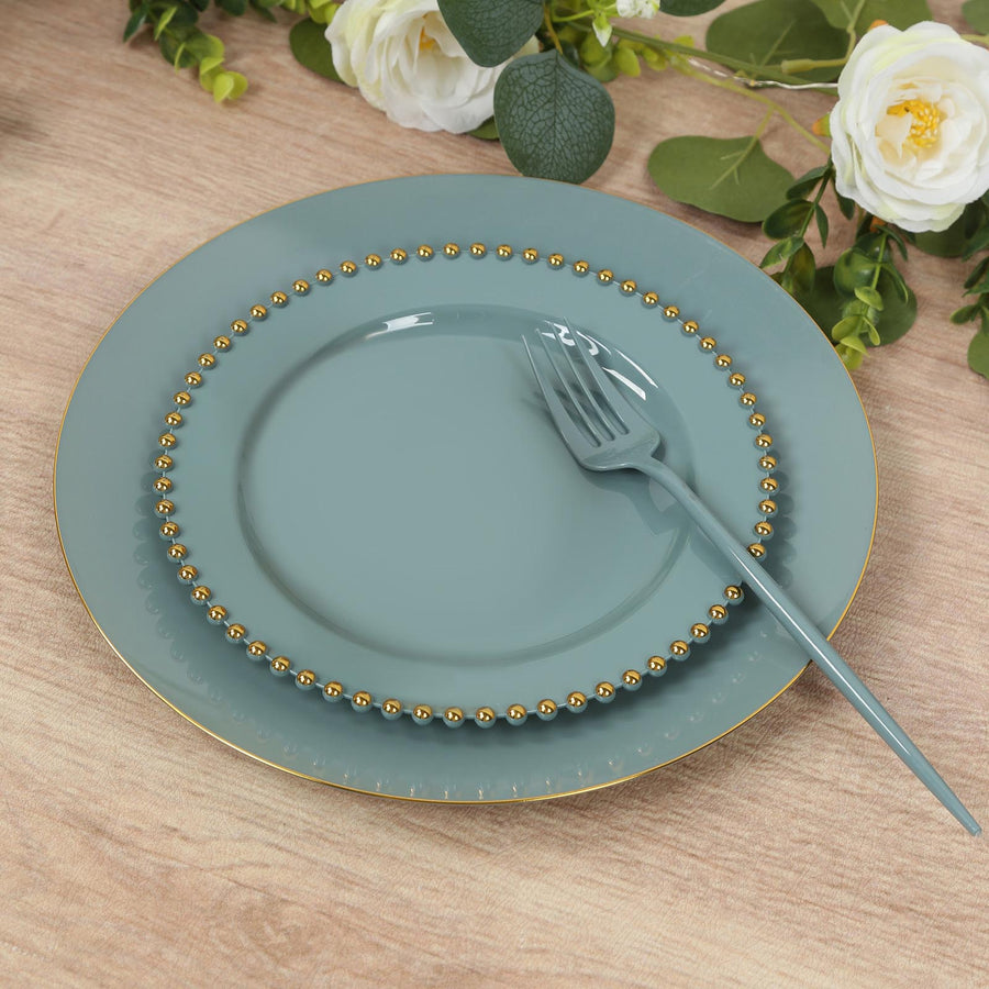Elegant teal dinner plate set with gold beaded rim and matching fork.