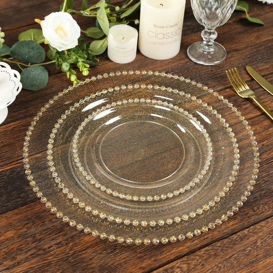 Elegant beaded glass dinner plates set on a wooden table.