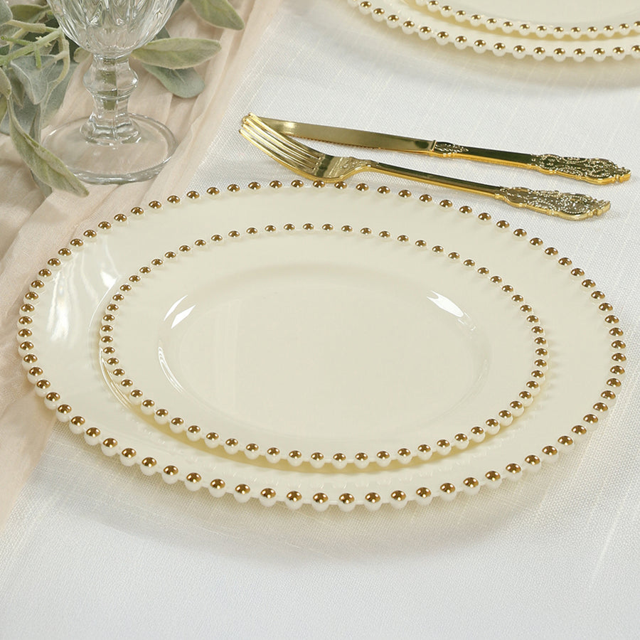 Elegant cream plates with gold beaded rim, perfect for formal dining.