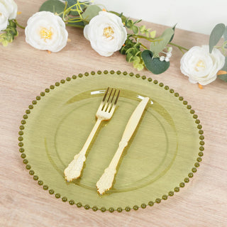 Elegant green plate with gold fork and knife set on a rustic wooden table.