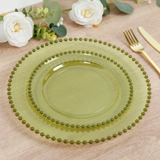 Green decorative plates stacked on a table with floral accents.