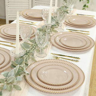 Elegant rose gold rimmed dinner plates set on a beautifully styled dining table.
