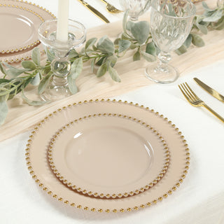 Elegant beige plates with gold beaded rim, perfect for dining settings.