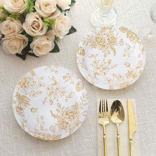 Elegant white plates with gold floral design on a table setting.
