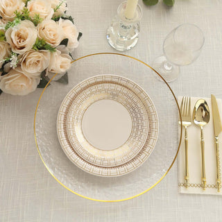 Elegant dining setting with gold-accented plates, cutlery, and floral centerpiece.