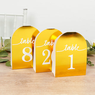 Gold table number stands for event decor, featuring numbers 1, 2, and 8.