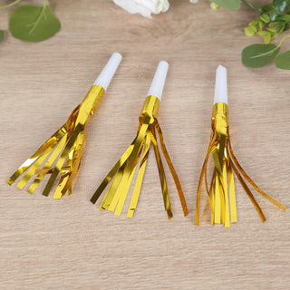 Gold foil party blowers in three styles on a wooden surface.