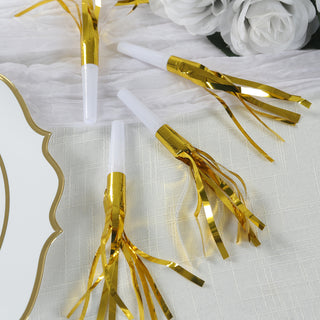 Gold and white party blowers with festive streamers on a table setting.
