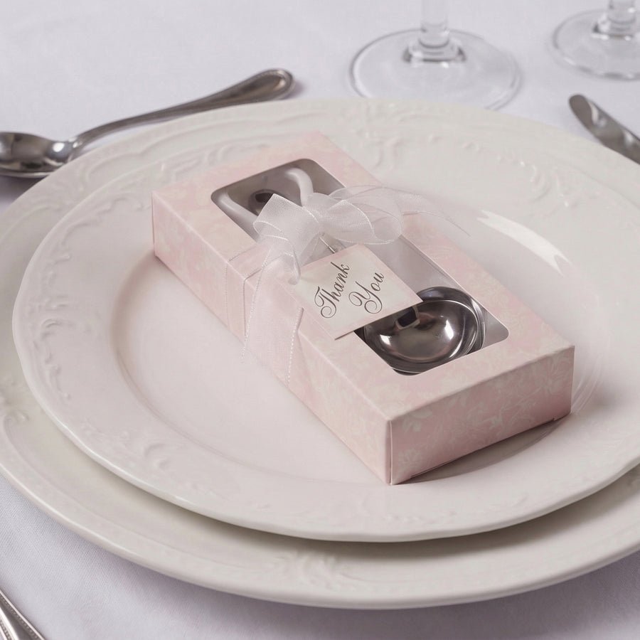 Thank you gift box with two spoons on an elegant dinner plate.