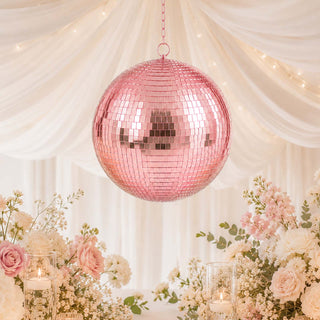 Pink disco ball wedding centerpiece with pastel flowers and candles