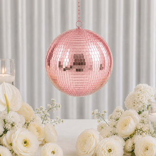 Pink mirrored disco ball centerpiece with white flowers and candles in elegant decor