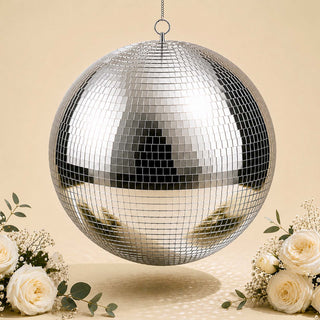 Silver disco ball hanging decoration with white roses on a beige background