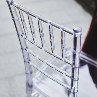 Clear acrylic chair back with elegant bamboo-style design.