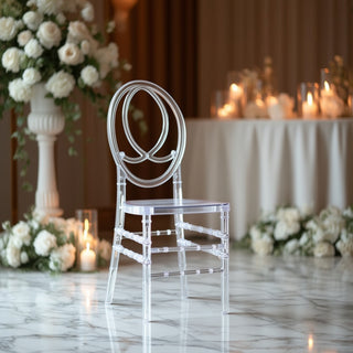 Elegant transparent chair with floral decor and candles in a sophisticated setting.