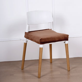 Brown cushion on white chair with wooden legs