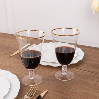 Elegant glassware with gold rim, perfect for wine or beverages.