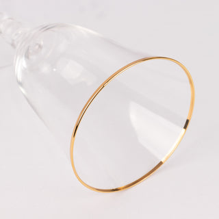 Clear glass with gold rim on white background