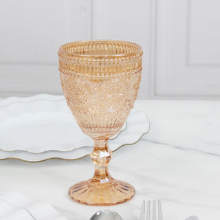 Vintage-inspired pink glass goblet on a marble table.
