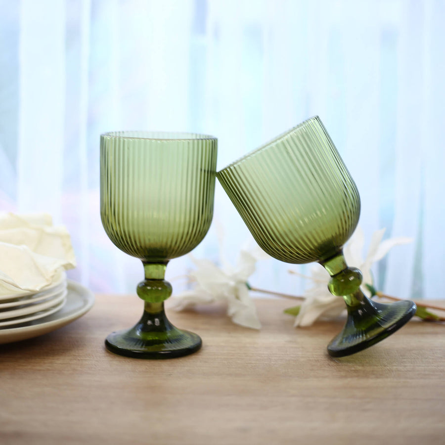 Green ribbed glass goblets on a dining table, elegant home decor display