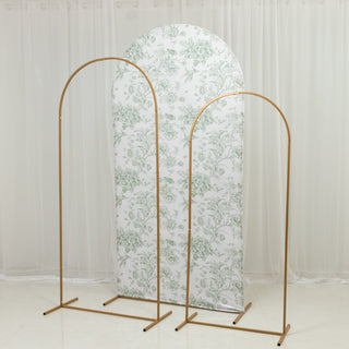 Gold metal clothing racks with floral backdrop in a studio setting.