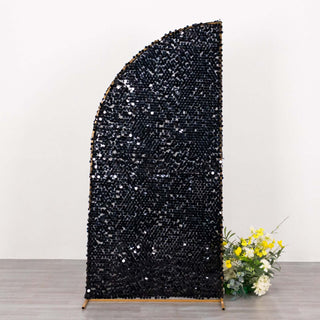 Black decorative screen with a unique curved design and floral arrangement at the base.
