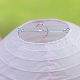 Pink paper lantern with metal hanging hook.