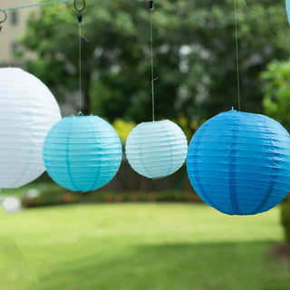 Hanging paper lanterns in shades of blue and white against a garden backdrop.